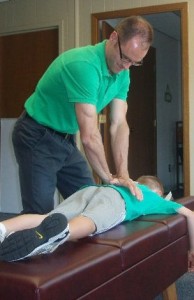Dr_Andy_Sommer_Adjusting_Boy_For_Subluxations__Sommer_Family_Chiropractic_Omaha_NE_Chiropractor_2